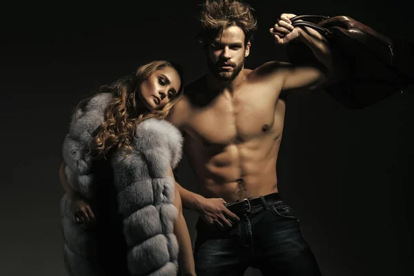 Macho with travel bag and girl in fur vest