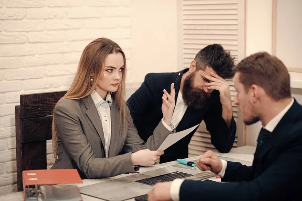 Woman accountant explain economic indicators. Business partners, disappointed businessmen at meeting, office background. Business negotiations, economist calculates losses. Business losses concept.