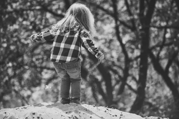 Niño con pelo largo y rubio en camisa, jeans al aire libre — Foto de Stock