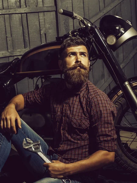 Bearded biker man with wrench — Stock Photo, Image