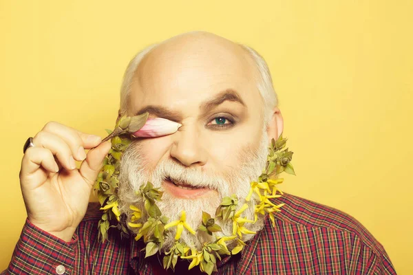 old man with flowers and leaves in beard