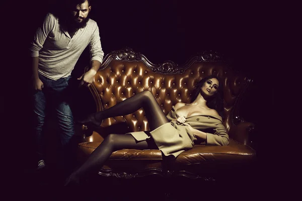 Stylish sexual couple on sofa — Stock Photo, Image