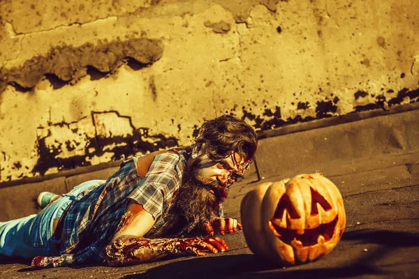 Zombie man crawls for pumpkin