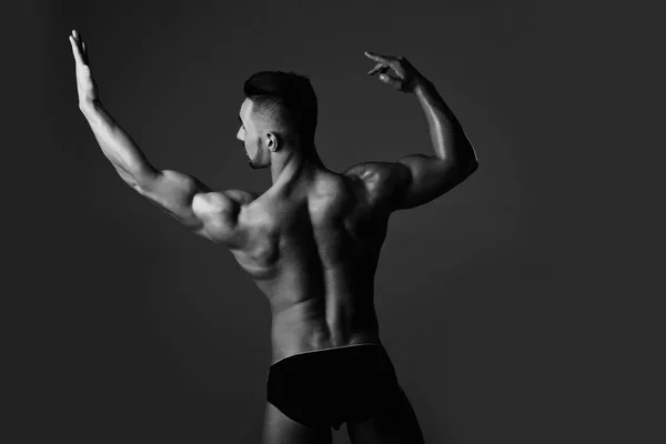 Homem muscular com tronco muscular mostrando bíceps e tríceps — Fotografia de Stock
