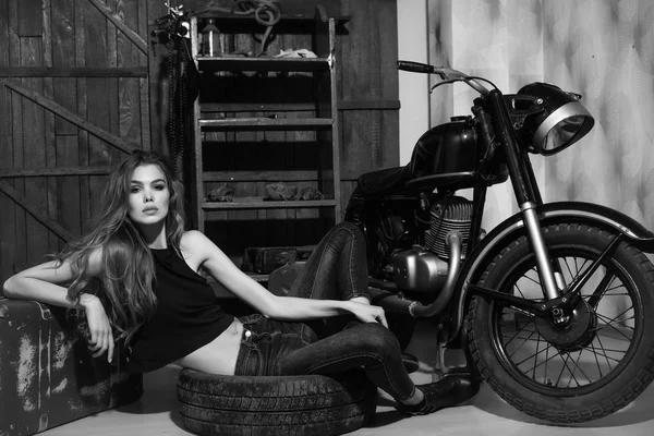床の汚いゴム製タイヤで横になっているセクシーな女の子 — ストック写真