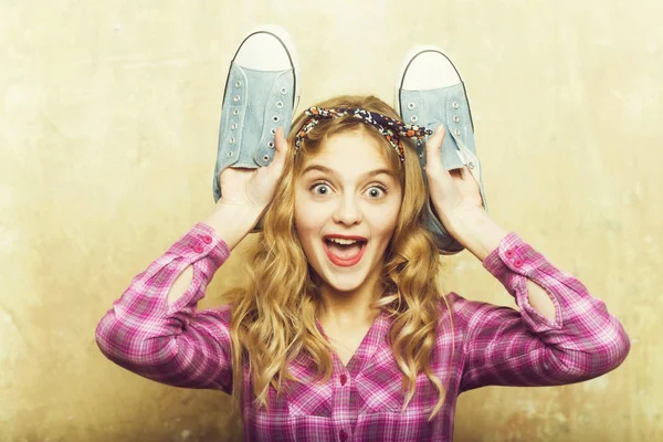 Amazed pretty girl with blue fashion sneakers in hands — Stock Photo, Image