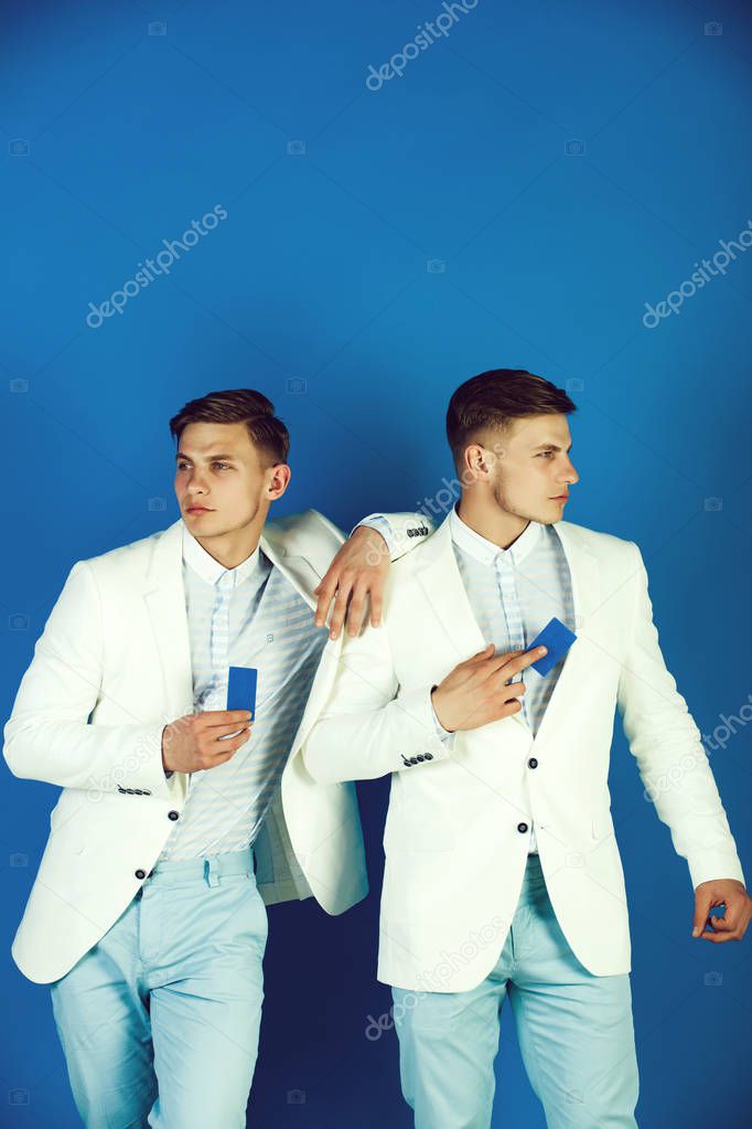 Men holding blank cards on blue background