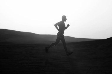 Dune günbatımında çalışan adam runner