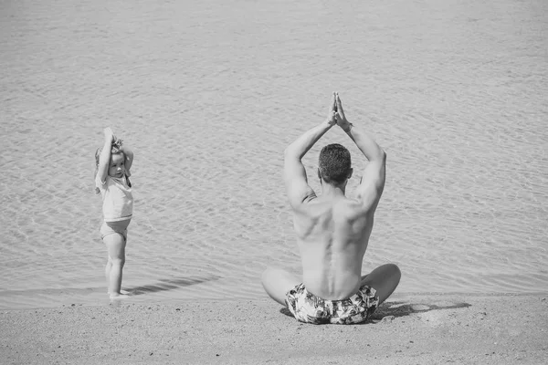 Padre hombre e hijo meditando en pose de yoga —  Fotos de Stock
