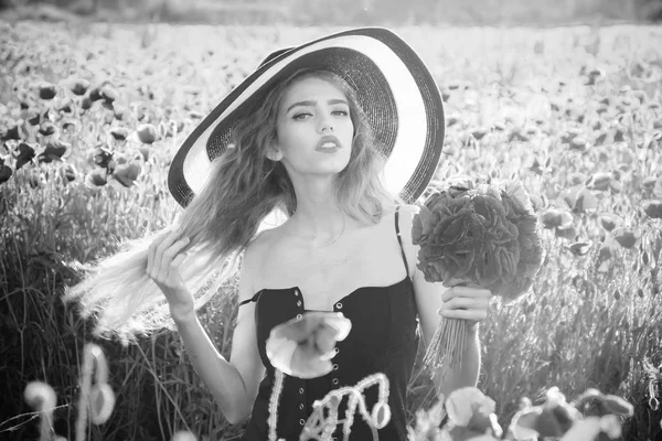 Hermosa chica con sombrero en campo de amapola roja — Foto de Stock