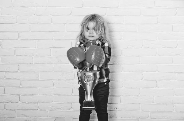 kid wearing boxing glove, boy boxer winning golden champion cup