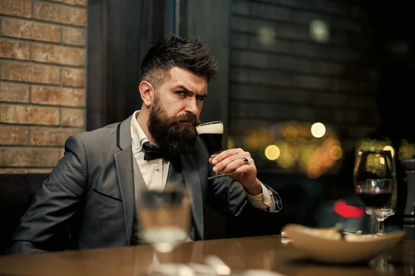 Serious bearded male drinking ale in pub — Stock Photo, Image