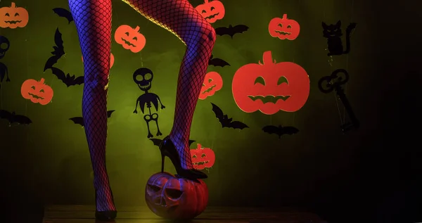 Holiday halloween with funny carnival costumes on a halloween background. 31 october. Sexy woman on Halloween background. Background decorated for Halloween.