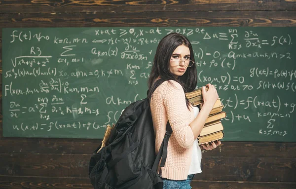 Side view fiatal diák halom matematika vizsga felkészülés könyvek osztályban. Gyönyörű college lány állandó osztályteremben — Stock Fotó