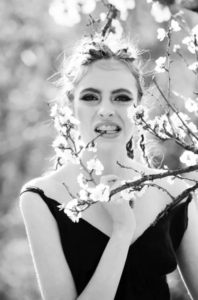 Girl in teeth braces eating white cherry spring flower blooming — Stock Photo, Image