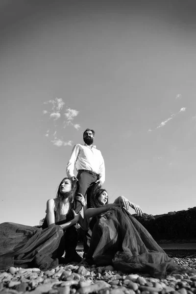 Bearded man and two women outdoor