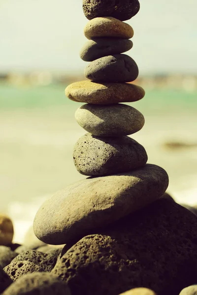 Grey stones or pebbles stacked in pyramid