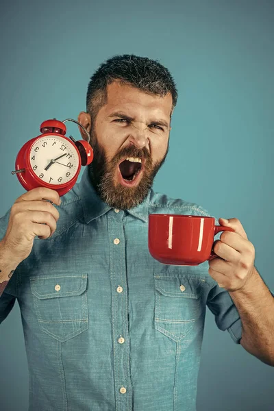 Red mug with alarm, perfect morning.