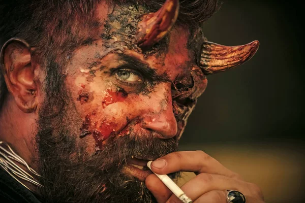 Halloween devil smoking cigarette — Stock Photo, Image