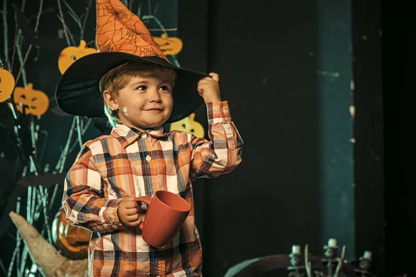 Halloween Boy kid with happy face at pumpkin.