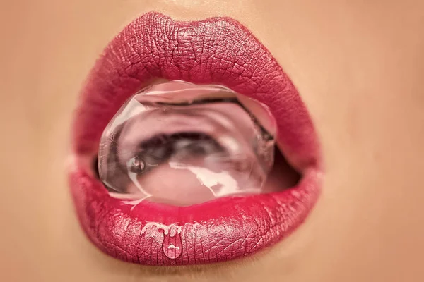Female mouth with ice cube