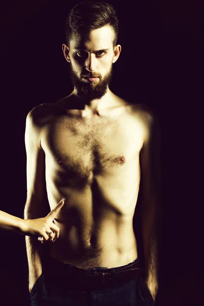 slim bearded man with thin bare torso isolated on black