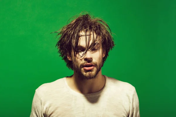 sleepy man with wet head, face and hair in morning
