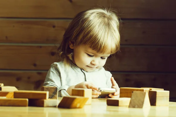 Small boy with computer and phone