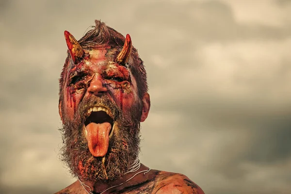 Halloween demon man with beard showing tongue — Stock Photo, Image