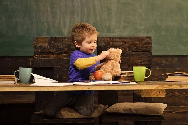 Kleiner Junge spielt in der Schulpause mit Teddybär niedliches Kind mit seinem Lieblingsspielzeug. Lernspiel im Kindergarten — Stockfoto