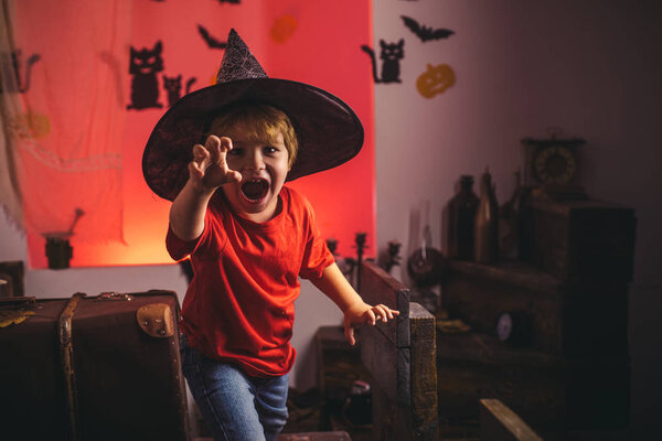 Halloween child decoration and kids scary concept. Halloween background. Magik halloween. Horror faces. Expression face - surprised cute boy.