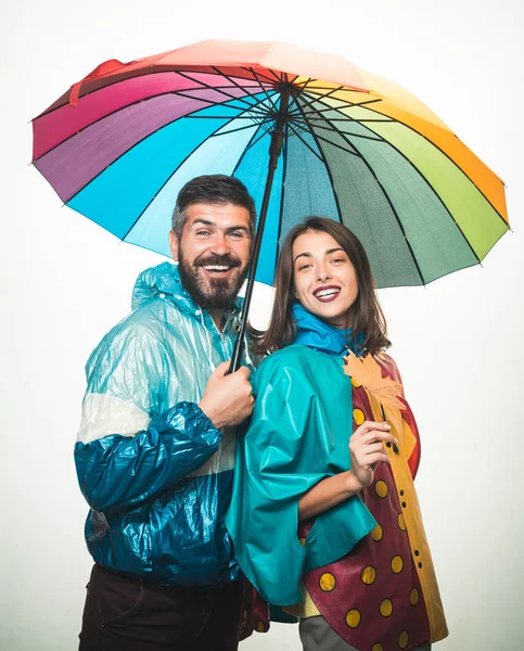 Couple wearing in autumn clothes. Surprised couple on autumn clothes discounts. Happy couple in love wearing in autumn clothes on autumn rain day.