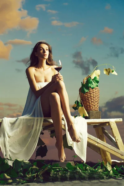 Pretty woman with wine over sky — Stock Photo, Image