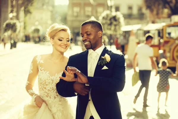 Happy african American groom and cute bride walking on street — Stock Photo, Image
