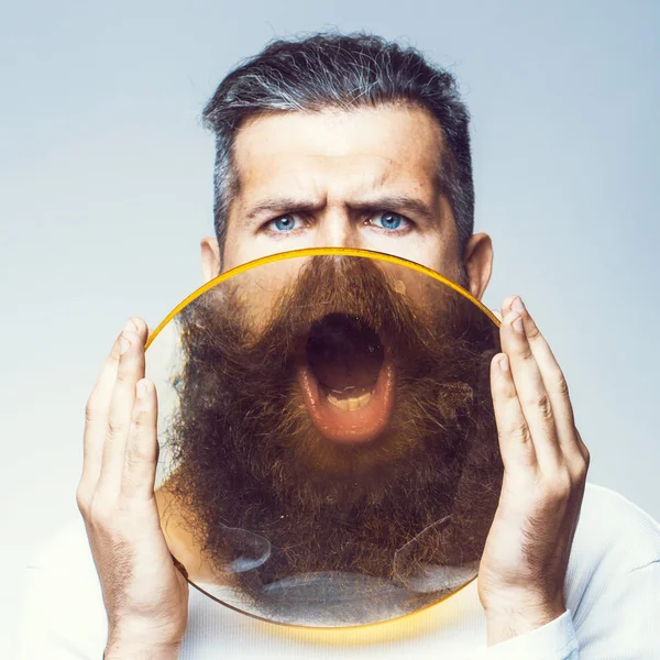 Bearded man with magnifying glass — Stock Photo, Image