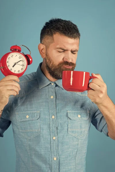 Red mug with alarm, perfect morning.