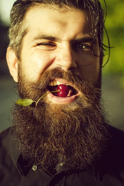 bearded man with red cherry