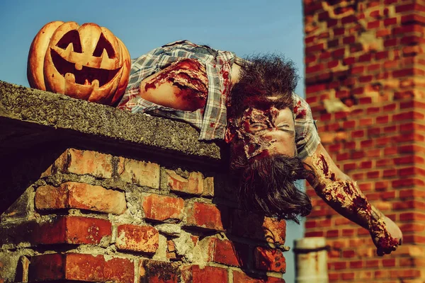 Zombie man lies on chimney — Stock Photo, Image