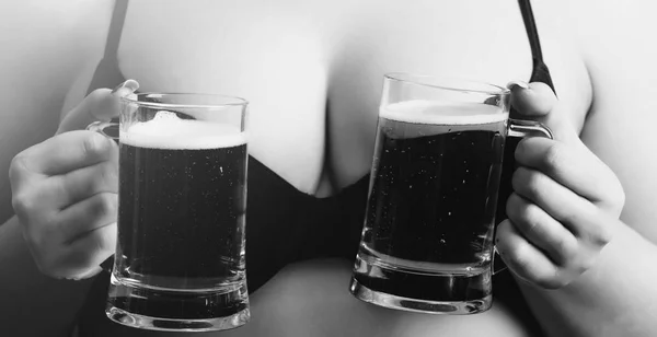 Beer in two glass mugs in female hands — Stock Photo, Image