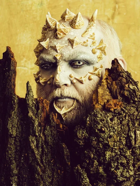 Man with dragon skin and bearded face