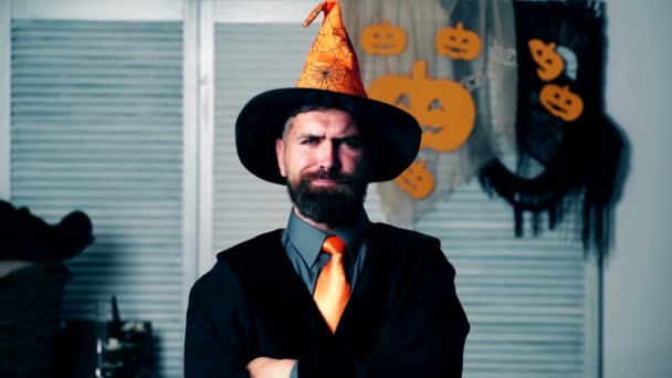 Bearded man in sorcerers suit raises his eyebrows. Halloween party and celebration concept. — Stock Video