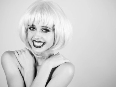 Parlak yapay saç ile gülümseyen kız.