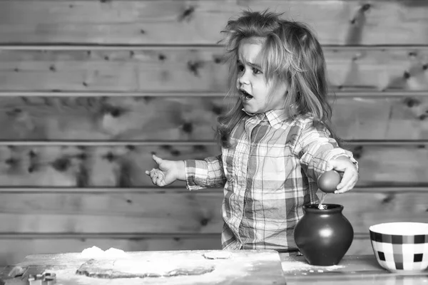 Cute child cooking with dough, flour, egg and bowl — Stock Photo, Image