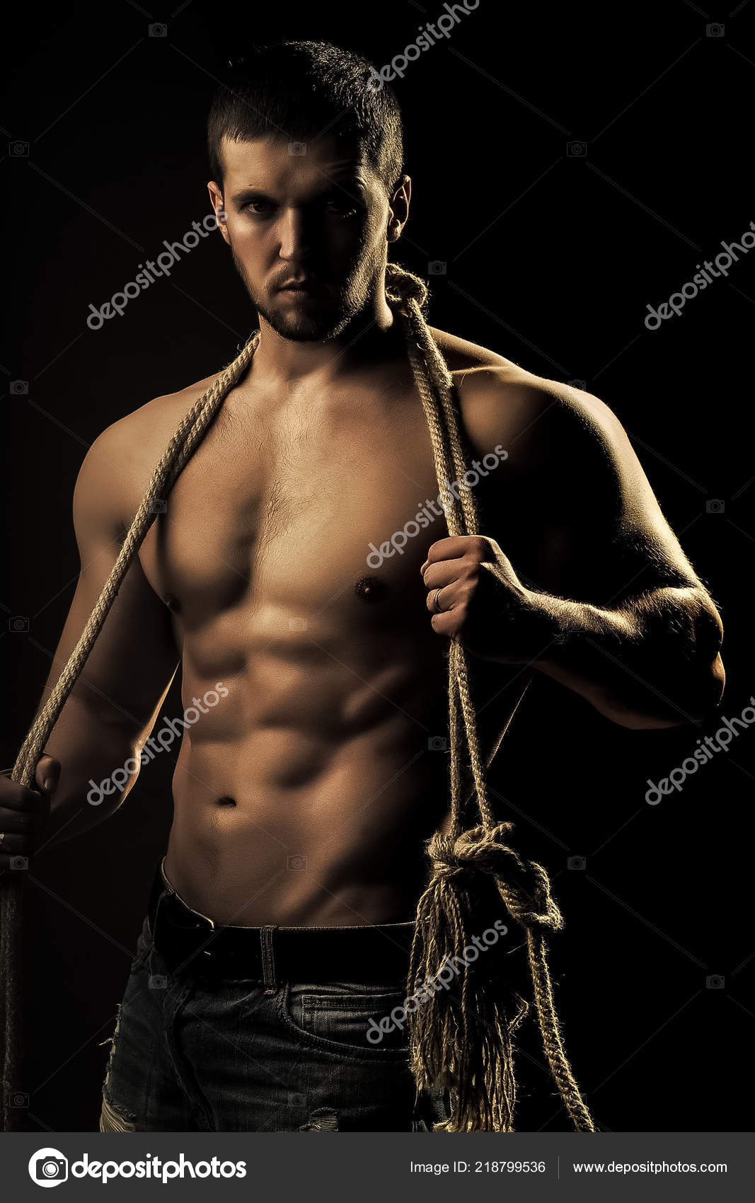 Muscular man with rope — Stock Photo © Tverdohlib.com #218799536