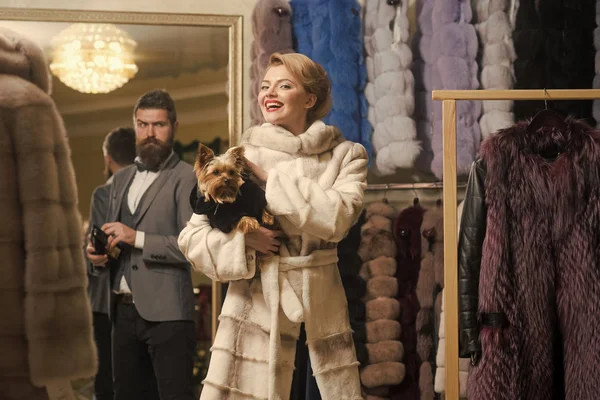 sensual woman in fur coat with man, shopping, seller, customer.