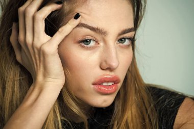 Makyajsız yüz ve uzun saçlı olan kadın