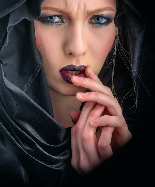 Look of woman with makeup in black hood. look and beauty fashion concept