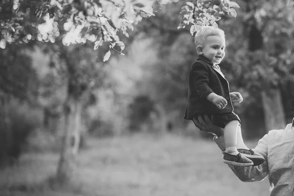 Söt liten knatte leende i sneakers under träd, mode, kostym, skjorta — Stockfoto
