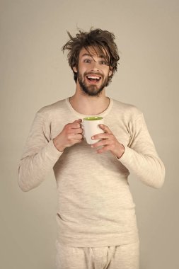 Man with disheveled hair drink mulled wine. clipart