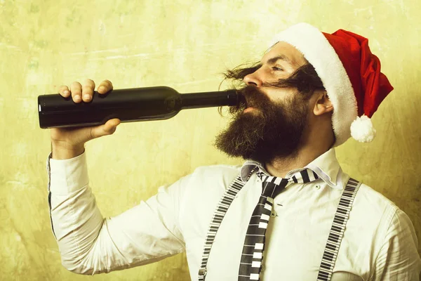 Santa claus man with wine bottle.